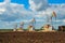 Four oil rocking chairs in a field with black soil