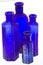 Four old blue glass medicine bottles
