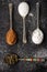 Four old spoons with white, icing sugar, green tea and cocoa powder