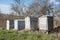 Four old wornout beehives on a row in the springtime