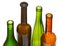 Four open bottlenecks of colored wine bottles