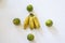 Four oranges and a bunch of yellow bananas in the center against a white background