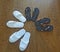 Four pairs of slippers, soft white and plastic brown, are on the floor.