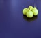 Four pears on purple background