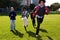 Four People Running Through an Urban Park