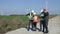 Four people standing in open field