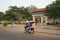 Four persons riding on one motorcycle heading for a school on National Highway 6 in Siem Reap,