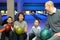 Four persons sit communicate in bowling club