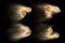 Four photos of sand explosion isolated on black background. Freeze motion of sandy dust splashing