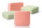 Four pieces of green and pink toilet soap on a white background. Full depth of field.