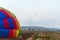 Four pilots on motorized parachutes fly over the flying field at the hot air balloon festival