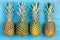 Four pineapples beside each other on table
