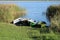 Four pleasure boats on the banks of a wide, deep river