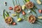 Four portions of raw meat nests with quail eggs, cucumers and st