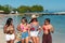 Four pretty girls strolling along the shore of the beach. They are having fun