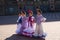 four pretty little girls dancing flamenco dressed in typical gypsy costume pose in a famous square in seville, spain. Flamenco,