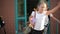 Four pupils are having fun after school lessons. They wear school uniform. School building is on background.