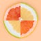 Four quarters of grapefruit and sweety on various colored backgrounds arranged