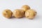 Four Raw Potatoes over white background