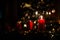 Four red candles - the first lighted candle of the first Sunday of Advent festival before Christmas with tree and decoration in ba