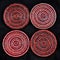 Four red and pink circular beaded drinks coasters