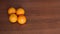 Four ripe juicy oranges on wooden background.