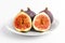 Four ripe organic figs displayed on a white plate on a table, close up of healthy food photographed with soft focus