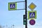 Four road signs and green traffic lightagainst blue background, Saint-Petersburg, Russia