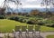 Four rocking chairs on a path overlooking a vineyard in Napa Valley