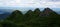 Four rocky peaks covered with dwarf pine