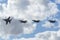 Four Royal Australian Air Force RAAF Boeing F/A-18F Super Hornet multirole fighter aircraft flying in formation.