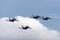 Four Royal Australian Air Force RAAF Boeing F/A-18F Super Hornet multirole fighter aircraft flying in formation.