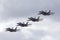 Four Royal Australian Air Force RAAF Boeing F/A-18F Super Hornet multirole fighter aircraft flying in formation.