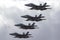 Four Royal Australian Air Force RAAF Boeing F/A-18F Super Hornet multirole fighter aircraft flying in formation.