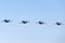 Four Royal Australian Air Force RAAF Boeing F/A-18F Super Hornet multirole fighter aircraft flying in formation.