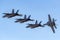 Four Royal Australian Air Force RAAF Boeing F/A-18F Super Hornet multirole fighter aircraft flying in formation.