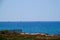 Four sailboats cruising the Mediterranean Sea