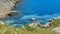 Four sailing boats anchor in a turquoise-colored bay on the island of Mallorca