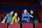 Four scared friends see movie in cinema theater