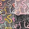 Four seamless patterns with colorful intertwined striped rain forest snakes