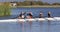 Four senior caucasian men and women in rowing boat high fiving