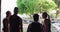 Four senior Caucasian men and women standing by a river talking