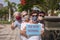 Four senior people enjoying together  nature in public park wearing face mask due to coronavirus, holding the message new normal