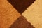 Four shades of brown wool textile texture background made from triangles