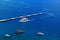 Four ships in the blue sea and pier, top view.