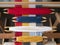 Four shuttles with yarn of different colors on the loom. Weaving shuttles with colored threads on the weaving project