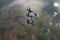 Four skydivers building a formation