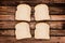 Four slices of bread, on wood planks