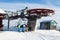 Four snowboarders descend to the ski chairlift.