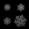 Four snowflakes isolated on black background